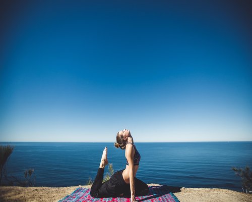 Woman doing gentle yoga stretching on floor at home